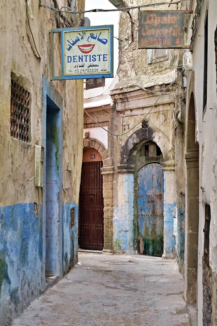 signages on walls of a narrow concrete alley